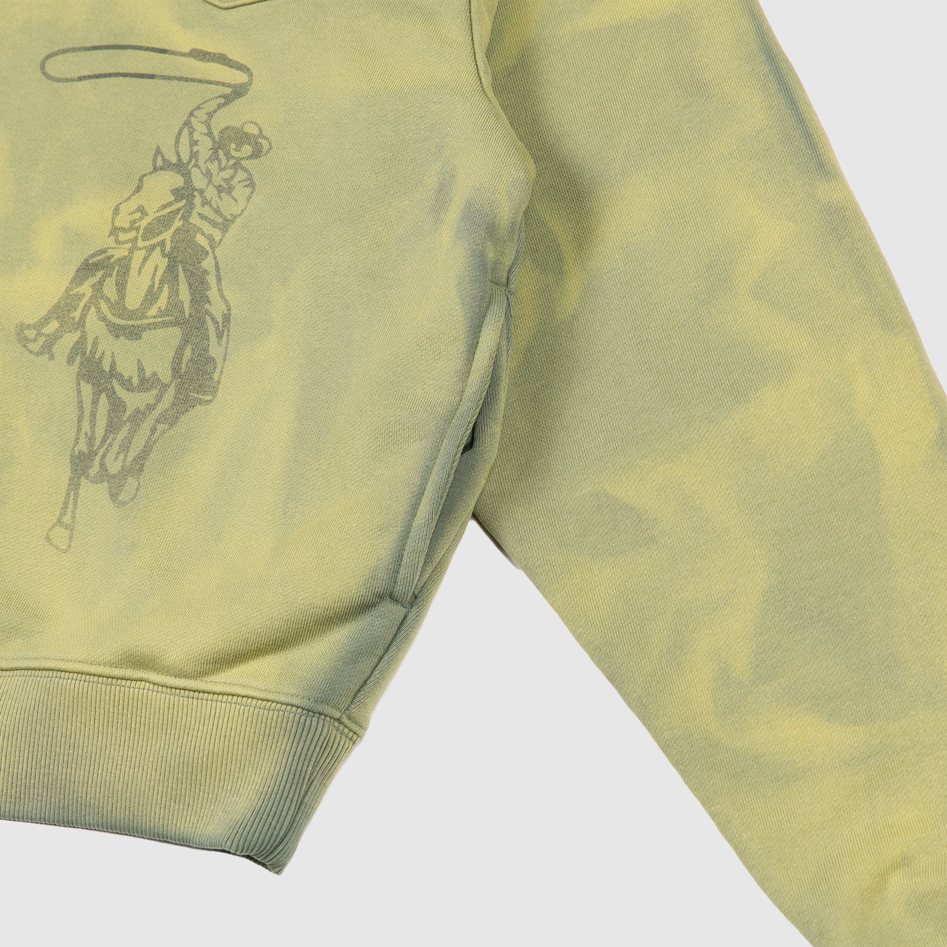 Side angle showing the cowboy graphic, sewn in side pocket, and ribbed waistband.